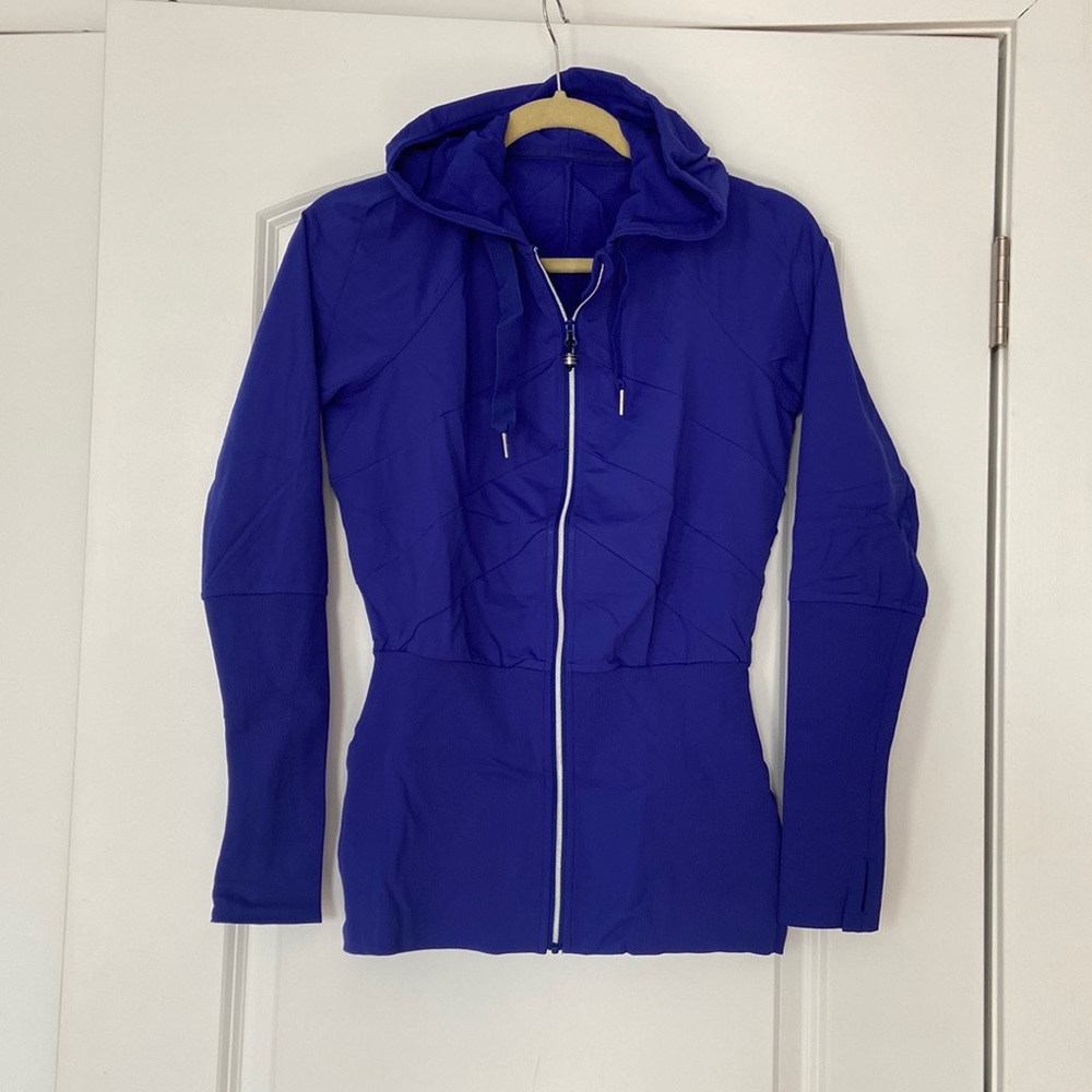 Size 4 blue lululemon zip front hoodie with thumb holes. Like new condition